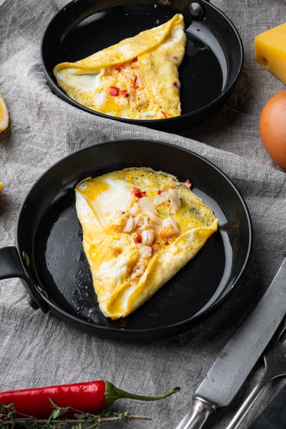 istock Chilli crab silky omlette , on frying iron pan, on gray background 1349318986