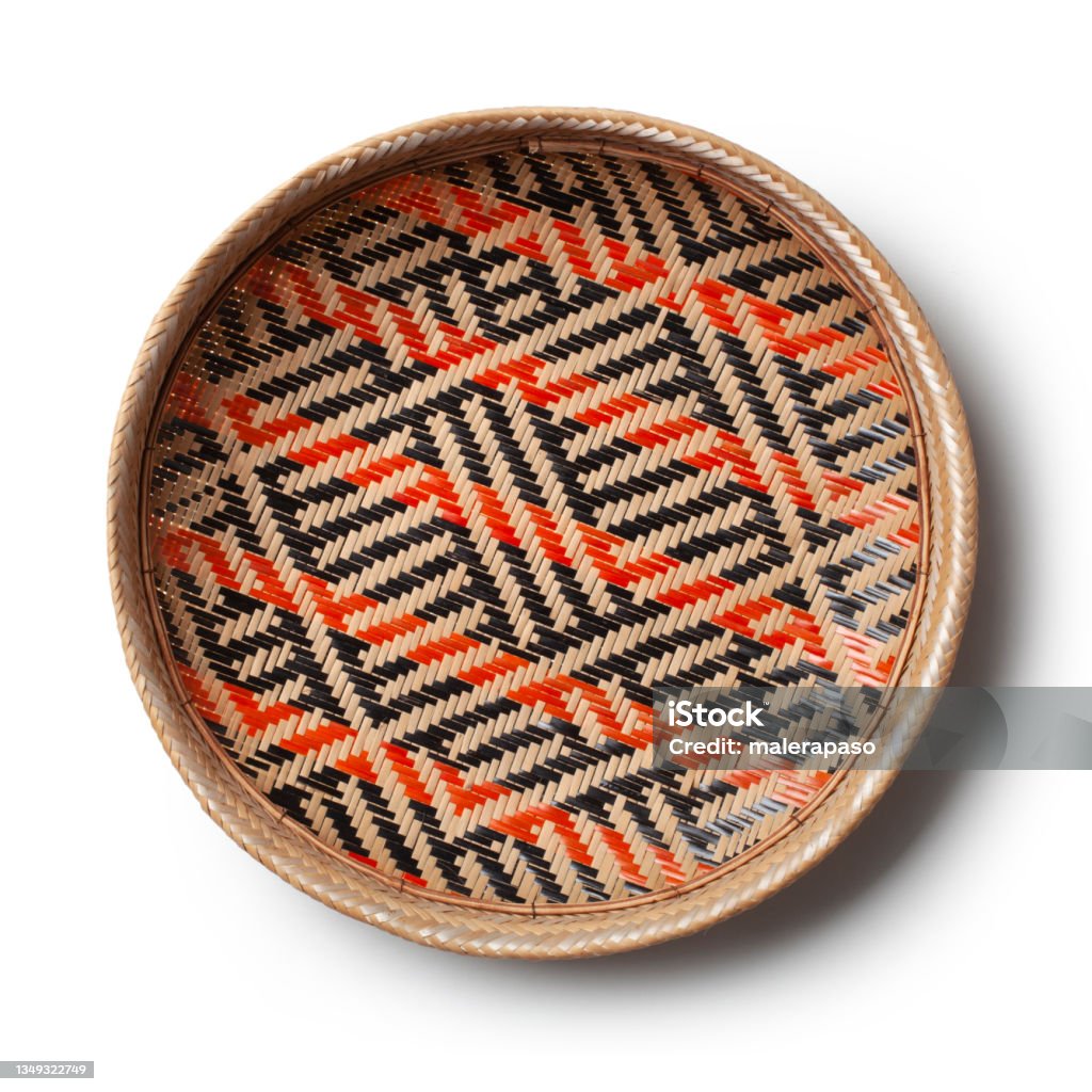 Basket on white background. Traditional handicraft product. Basket is handmade and is colored using natural dyes. The designs are ethnic in origin. Handicraft product of Indigenous tribes in Brazil. Indigenous Culture Stock Photo