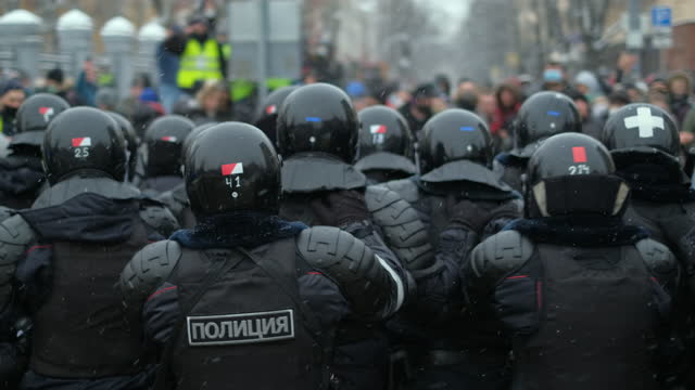 OMON, Russian riot police, attacks activist crowd in pushing line of officers.