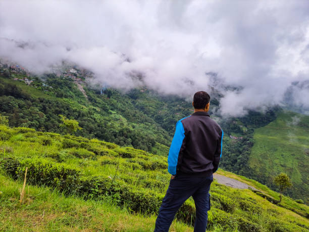 istock man standing at mountain top with dramatic sky at morning 1349323716