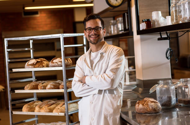 istock Portrait of young male baker standing at bakery. 1349324233