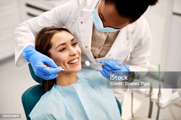 Young Happy Woman During Dental Procedure At Dentists Office Stock Photo - Download Image Now