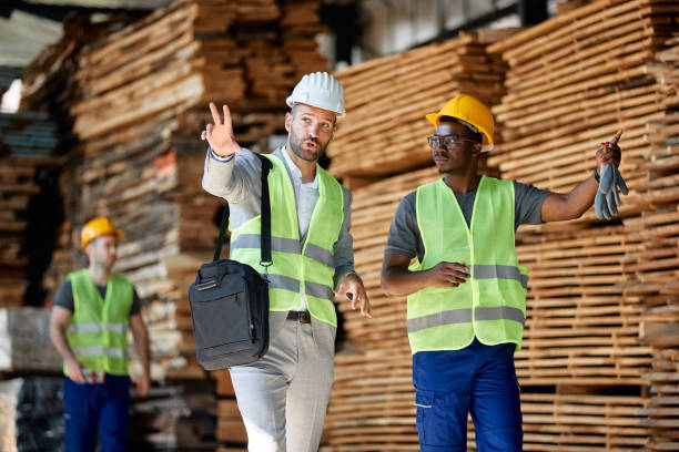 istock African American worker and businessman communicating while walking through lumber warehouse, 1349328711