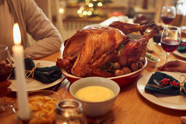 istock Traditional Thanksgiving turkey during family meal on dining table. 1349328737