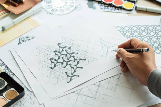 istock Designer designing drawing sketch pattern geometric flower seamless wallpaper fabric textile fashion industry. artistic design studio. 1349328903
