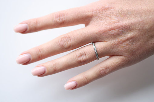 Silver ring with small stones on a woman hand. Jewelry concept