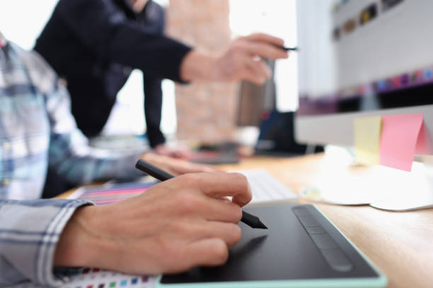 istock Two graphic designers working in office closeup 1349329625