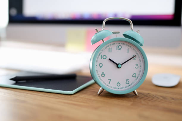 istock Alarm clock for ten in morning is on desktop in office 1349329648