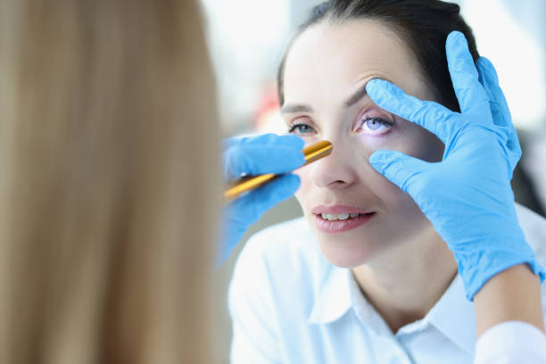 istock Doctor shines laser into patient eye closeup 1349329712