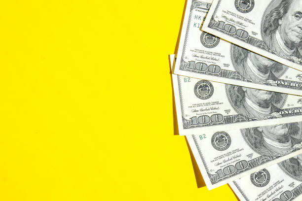 istock Us dollar bills in creative layout. Business concept, development perspective. Flat lay. Top view. Minimal creative style pattern. Copy space. Yellow background 1349330098
