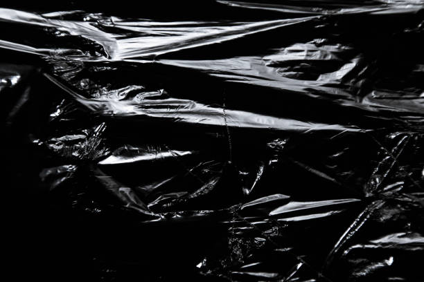 istock Photo of the polyethylene surface with ragged hole on black background 1349330236