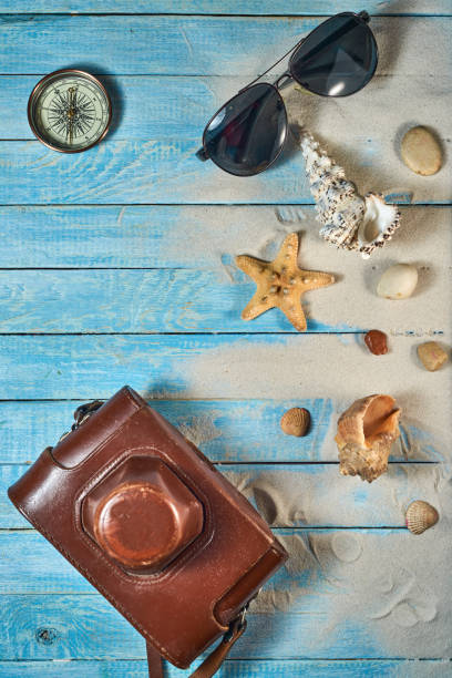 istock Summer still life on a wooden background, sea shells, glasses, starfish 1349330348
