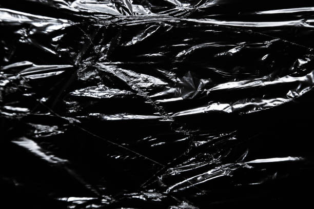 istock Image of the polyethylene surface with ragged hole on black background 1349330349