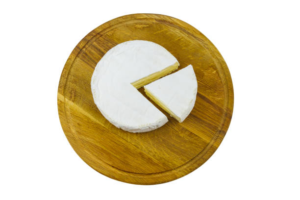 istock Piece of brie cheese on cutting board isolated on white background 1349331015