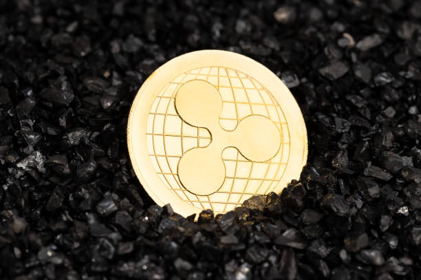 Ripple XRP coin on black gravel background stock photo