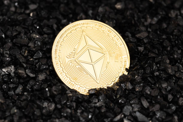 Ethereum classic coin on black gravel background stock photo