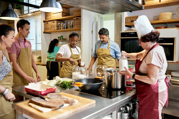 istock Diverse Group of Adult Students and Chef in Cooking Class 1349332366
