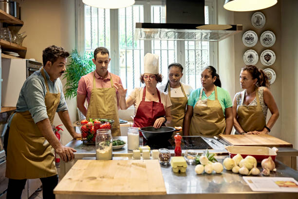 istock Senior Chef Instructing Adult Students in Cooking Class 1349332392