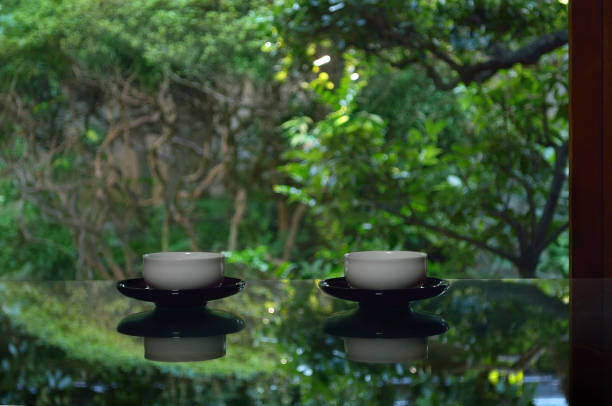 istock Cups of Green Tea on the Table surrounded by Trees 1349334922