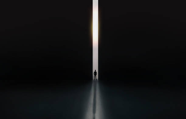istock Businessman in black suit stand between huge gate dark tone with confidence to present feel freedom, discovery new idea, find opportunity for business. 1349336099