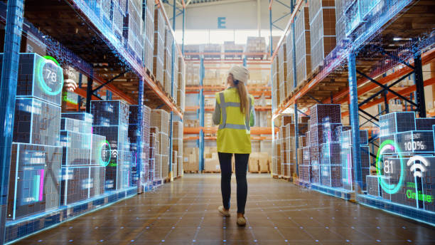 futuristic technology retail warehouse: worker doing inventory walks when digitalization process analyzes goods, cardboard boxes, products with delivery infographics in logistics, distribution center - mercadoria imagens e fotografias de stock