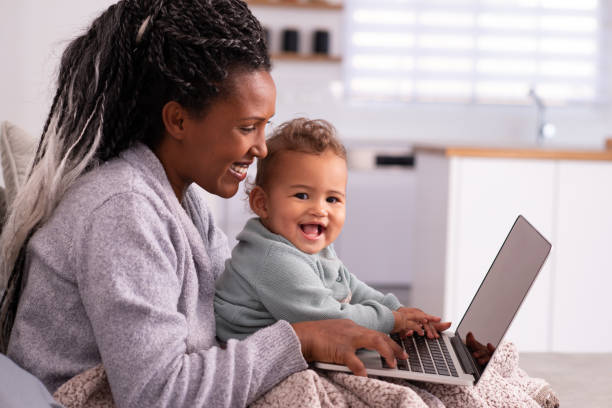 istock Multi-tasking mother working online at home. 1349340518