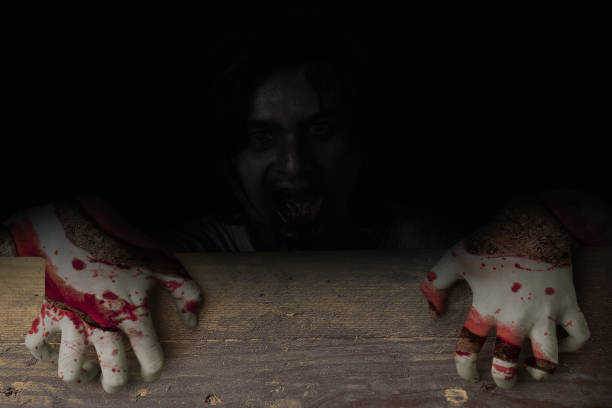 istock Scary zombies standing behind the wooden wall 1349341340