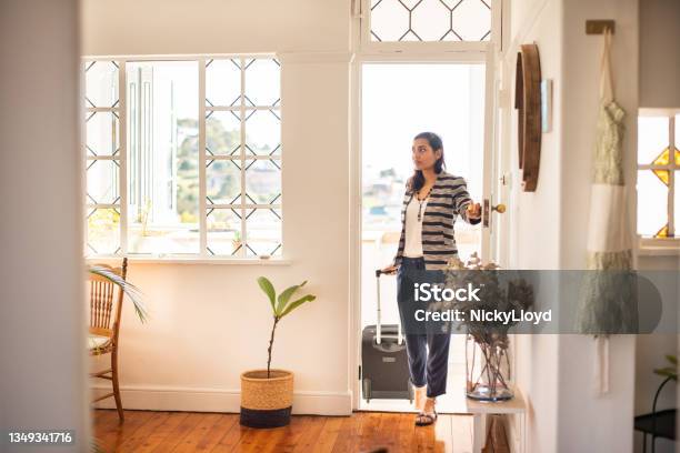 Young Woman With A Suitcase Arriving At Her Vacation Rental Accommodation Stock Photo - Download Image Now