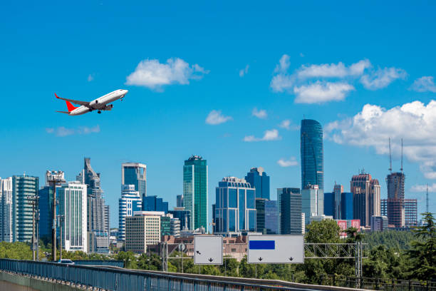 Passenger plane taking off over the city stock photo