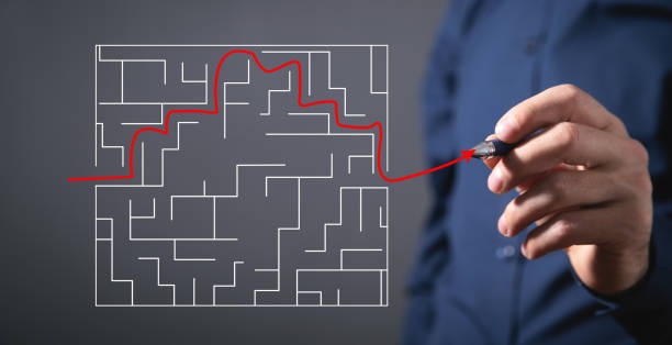 istock Businessman drawing labyrinth in screen. Find a solution 1349342727