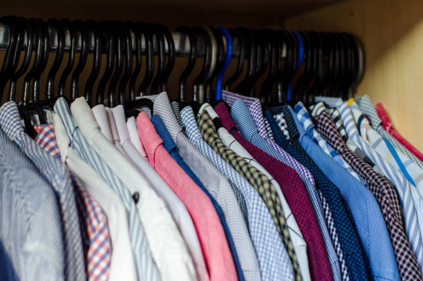 istock Men's shirts on hangers in the wardrobe 1349343098