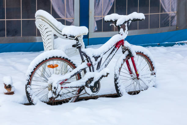 Snow covered bicycle at a tent on a winter campsite