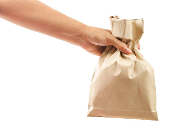 istock Hand holding paper bag isolated on white background, 1349345111