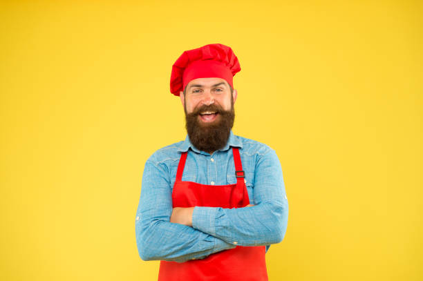 istock Every need catered. man cooking on kitchen. Professional chef man excited. excellent cook or baker. special offer from chef. chef in restaurant kitchen. mature male chef on yellow backdrop 1349346421