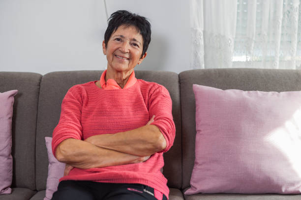 istock Smiling elderly woman resting on the couch 1349346474