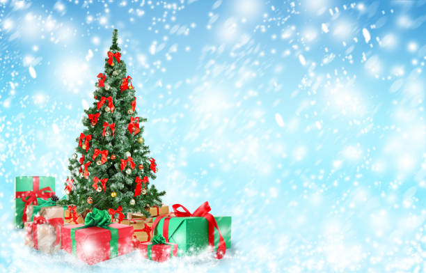 istock Beautiful Christmas tree with gifts under snowfall, space for text 1349348138