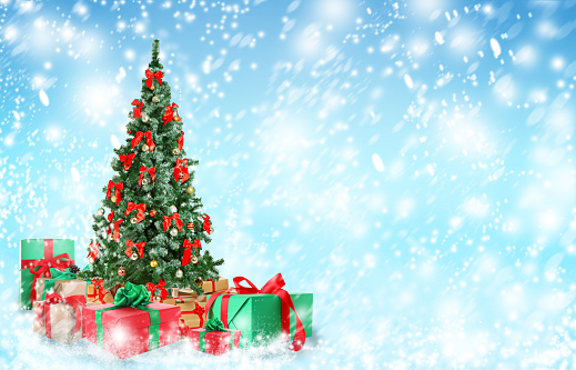 Beautiful Christmas tree with gifts under snowfall, space for text