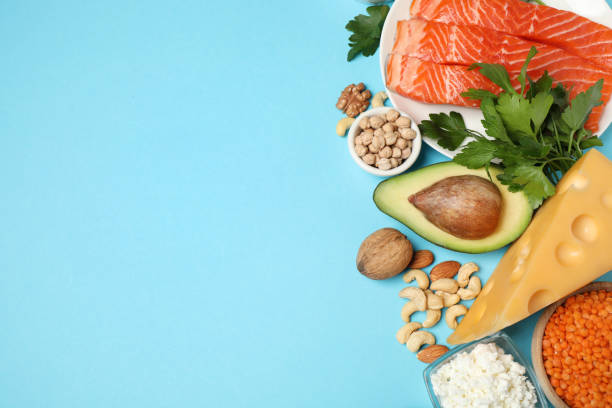 istock Different products rich in protein on light blue background, flat lay. Space for text 1349348504