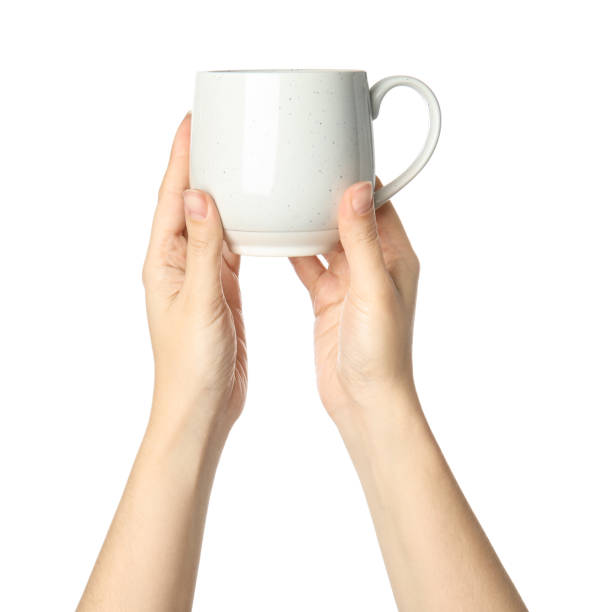 istock Woman holding ceramic cup on white background, closeup 1349349209