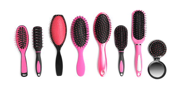 Set of modern hair brushes isolated on white, top view