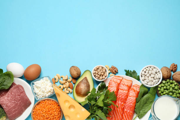 istock Different products rich in protein on light blue background, flat lay. Space for text 1349349672