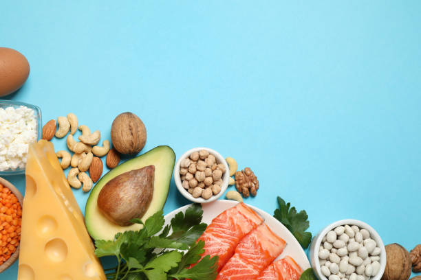 istock Different products rich in protein on light blue background, flat lay. Space for text 1349352564