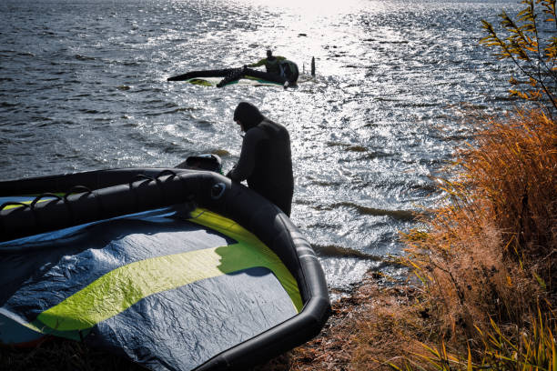 istock Athletes with wingfoil equipment enter the water 1349354635