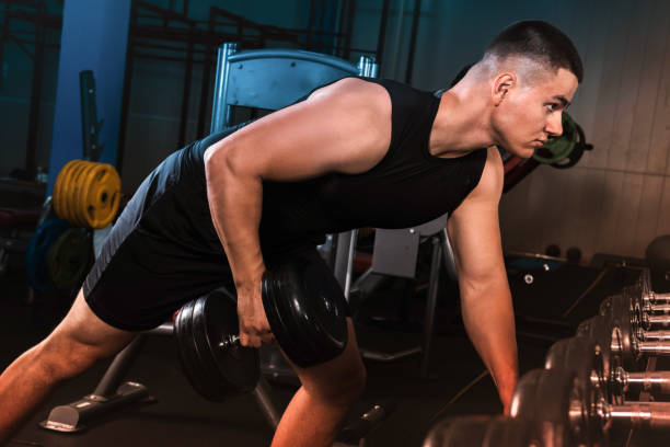 istock A young guy works out in the gym. 1349355202