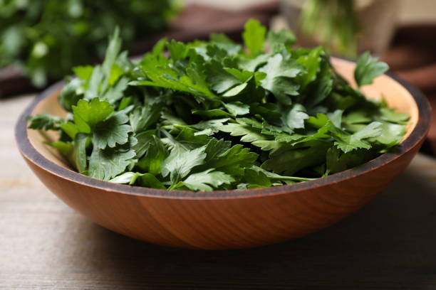 istock Fresh green parsley in bowl on wooden table 1349358750