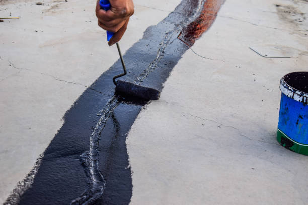 istock a painter is putting ceiling joint coating black paint on the rooftop 1349360092