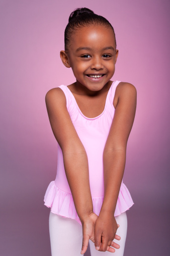 Portrait of a cute little African American girl wearing a ballet costume