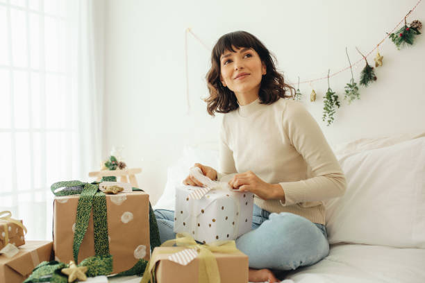 istock Woman decorating christmas presents 1349361718