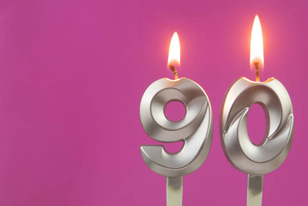 istock Silver birthday candles on pink background with room for text, number 90 1349363153