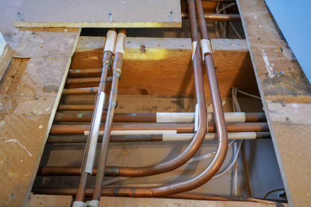 istock Close up of copper pipes under floor boards 1349365086